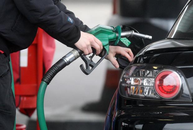 Wiltshire Times: Someone using a fuel pump at a petrol station (PA)