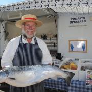 Ken Langley, of Ken’s Fresh Fish, with a Shetland salmon at Melksham Market Photo: Trevor Porter 66916-1