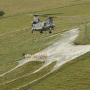 A heavy lift helicopter drops Chinook drops the tonne bags of Chalk at the Alton Barnes White Horse Photo Trevor Porter