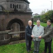 Chairman of Civic Trust Glyn Bridges, left, at the mausoleum. The bronze doors had been stored inside for safekeeping, Chairman of Friends of the Down Cemetery and Cllr Edward Kirk at the Roger Brown mausoleum with replacement wooden doors after the