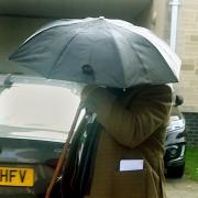 Timothy Wilsdon, who wore a scarf and used an umbrella to prevent his face being pictured as he left court yesterday GNS