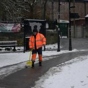 Snow scenes in Trowbridge - a council worker clears snow from a path in the town park. Photo: Trevor Porter 69680-2