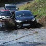Cars tackle the floodwater at Westbrook