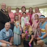 Elisa Francis as Barbie and Francis Willamin as Ken with staff and friends at the Oaks all dressed in pink for the Barbie-themed annual summer fete.