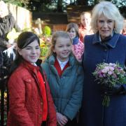 Lily King and Florence Crossman present a posy to the Duchess of Cornwall, now Queen Camilla, in Seend two years ago.