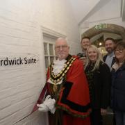 Trowbridge Mayor Cllr Stephen Cooper cuts the tape to officially open the Hardwick Suite, together with people that made it possible.
