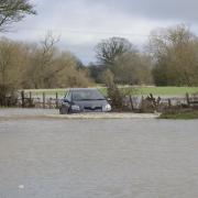 The water was up to the headlights on this vehicle but with no flood barriers in place this motorist attempted to drive through the floods  on the Staverton to Holt road.