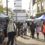 The busy Trowbridge Weavers Market in Fore Street with shoppers and stall holders enjoying the April sunshine.
