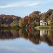 Looking across the lake towards the Pantheon with autumn colours, at Stourhead, Wiltshire