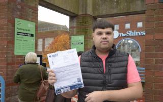 Lewis Edwards with his parking charge he claims he shouldn't have to pay.